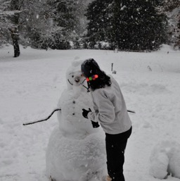 Assana fixing up the snowman/
		    