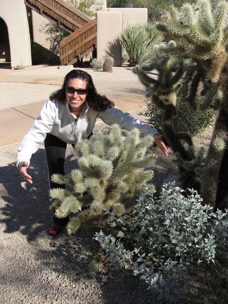 Assana can't help hugging the prickly pears/