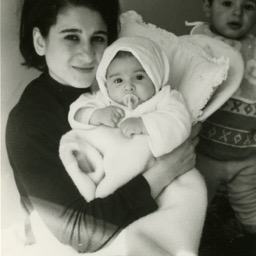 Aunt Karman holding Assana with Koohy looming in the back