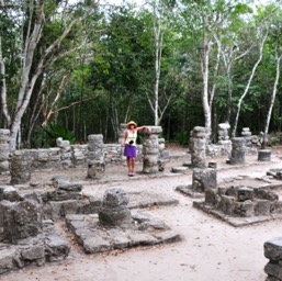 Assana with her arm on the walkway's roof; the Mayans were tiny people!/
		    