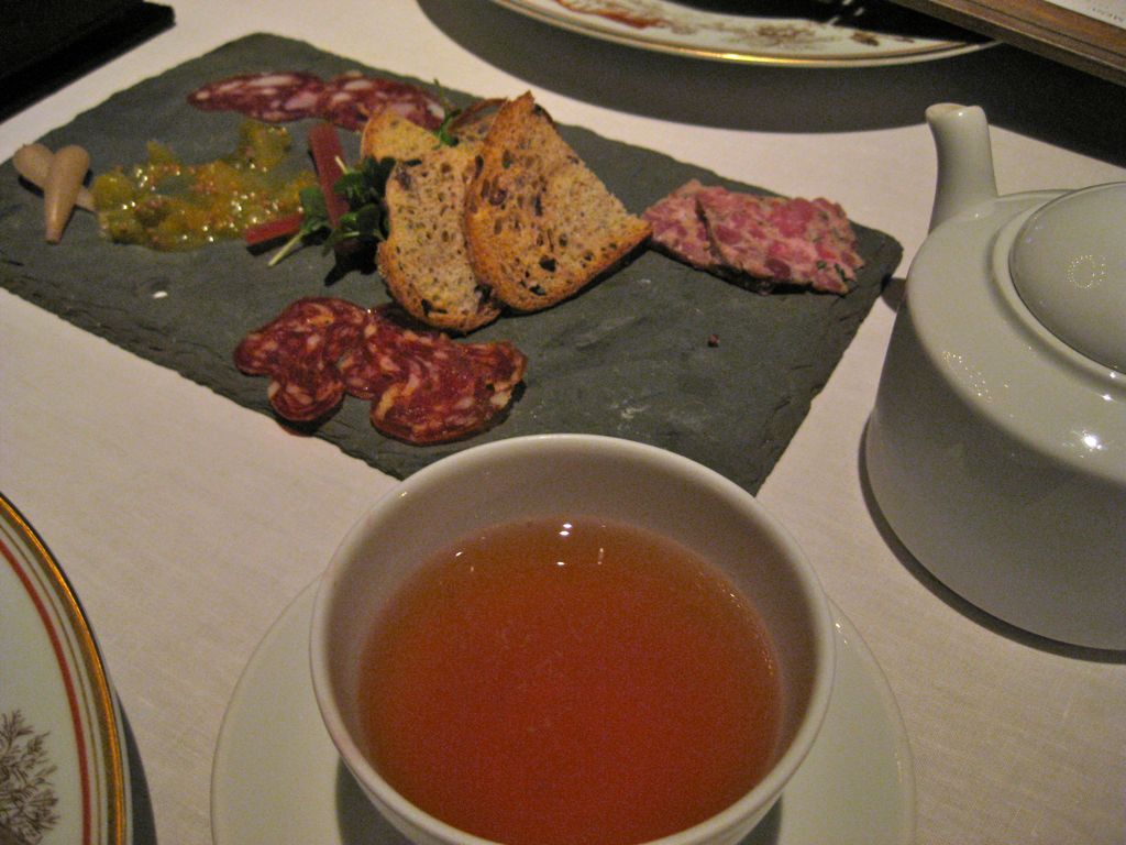 Charcuterie and beer served in a tea-cup/